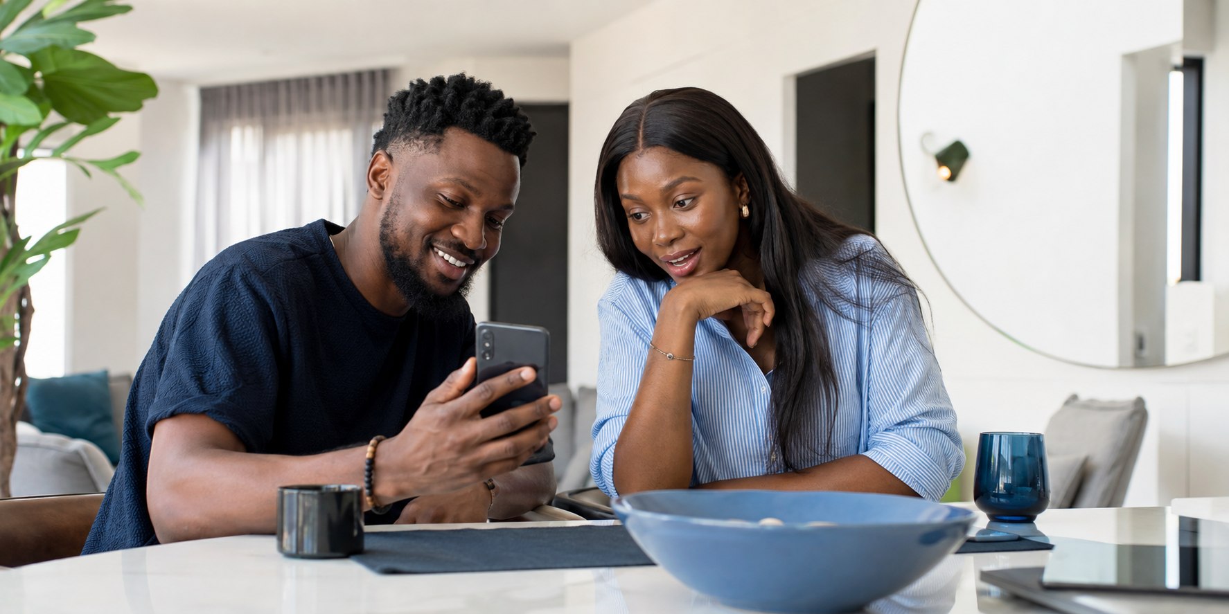 Two friends reviewing a payment on a phone